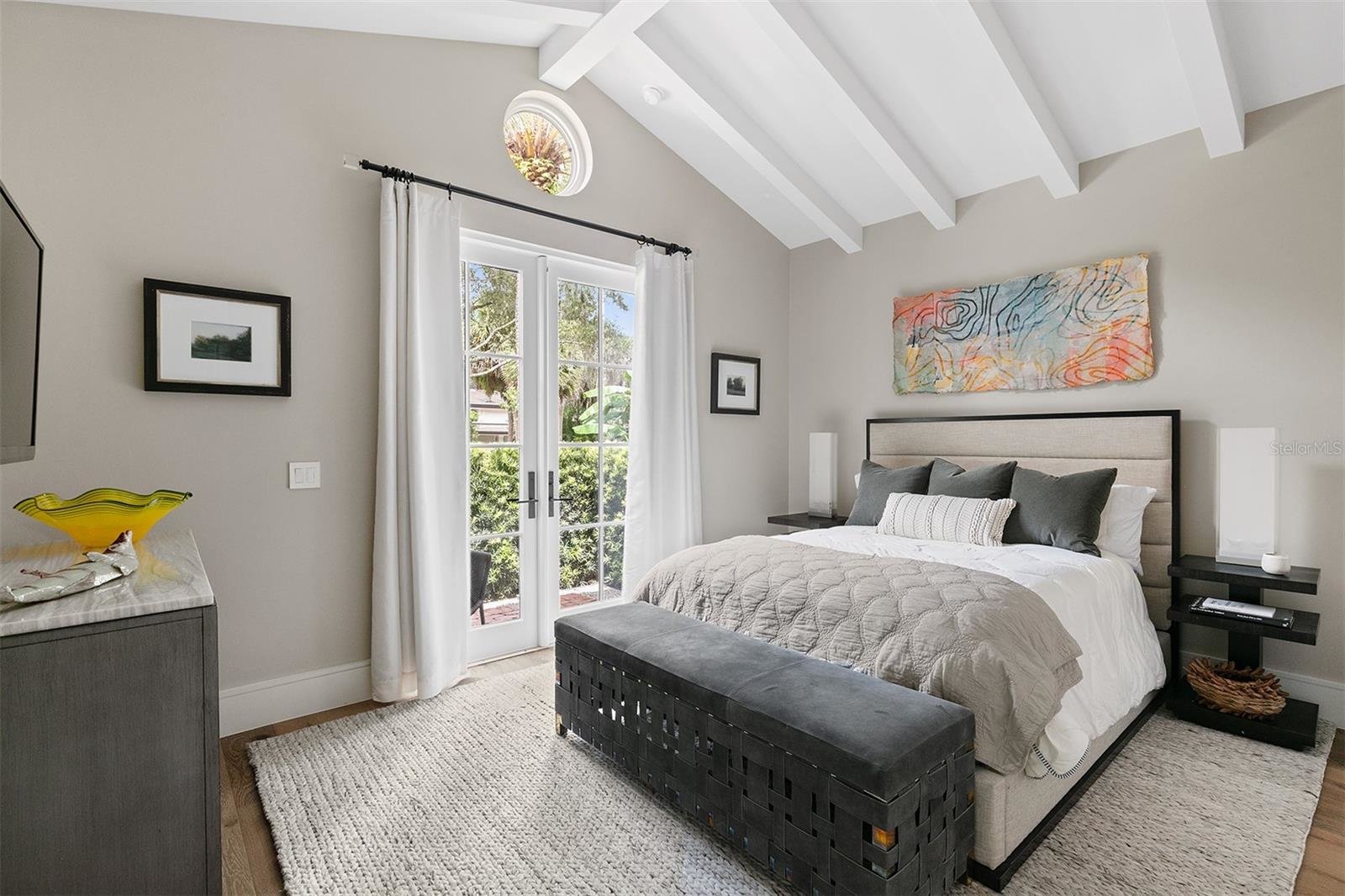bedroom with grey comforter on bed and white slated ceiling